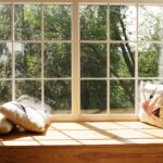 Modern window with pillows, trees and sky behind